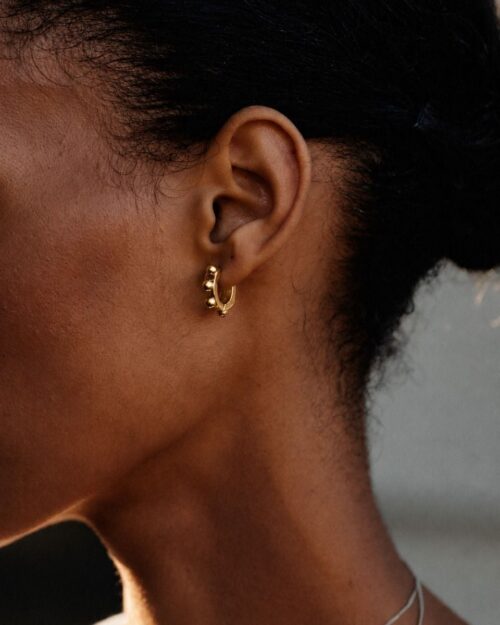 Edblad Stud Hoops Gold Earrings worn on the ear