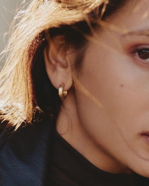 Edblad Wildern Hoops Gold Earrings worn on the ear