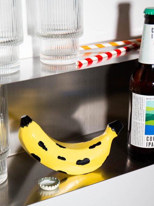 DOIY Banana Bottle Opener Large in a home bar setting