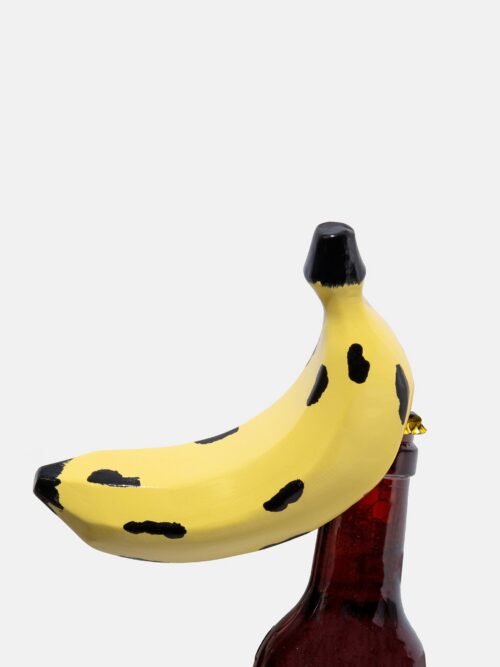 DOIY Banana Bottle Opener Large opening a bottle from another angle