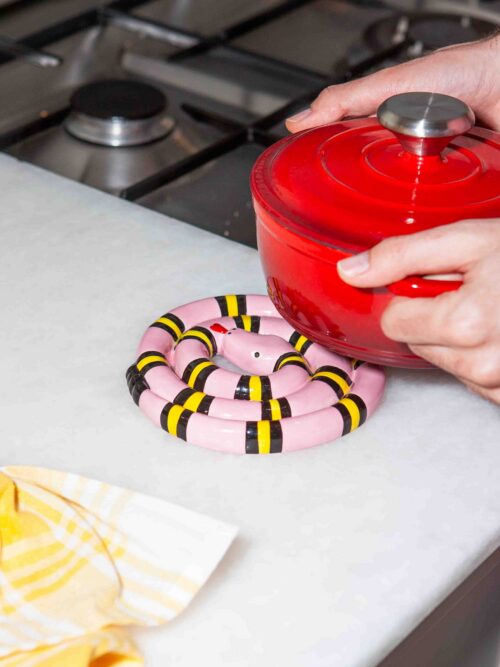 DOIY Snake Trivet Pink under a hot casserole
