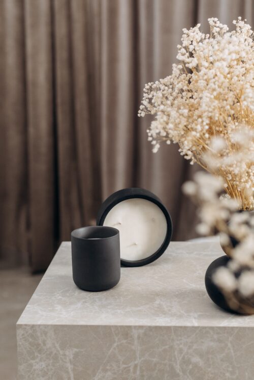 o k o Scented Candle Blackcurrant, 220 g in an interior setting