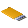Secrid ochre-yellow cardholder with cards extended on a white background