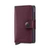 Secrid cranberry-red leather wallet closed on a white background