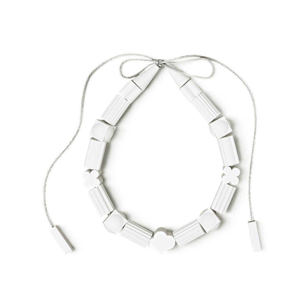 THE AIR Marshmallow white necklace arranged on a pure white background