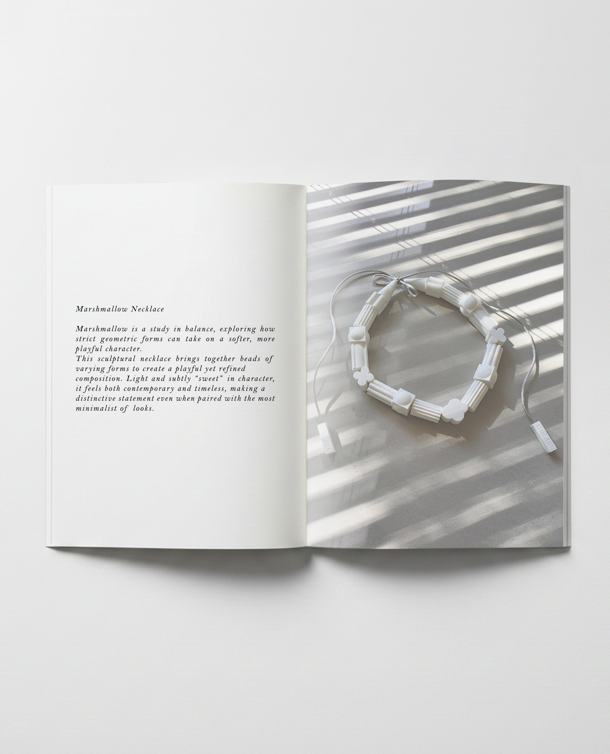 THE AIR Necklace Marshmallow displayed in an open magazine