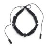 THE AIR Salmiakki black necklace arranged on a pure white background