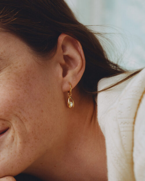 Edblad Moonrave Hoops L Gold Earrings worn by a model