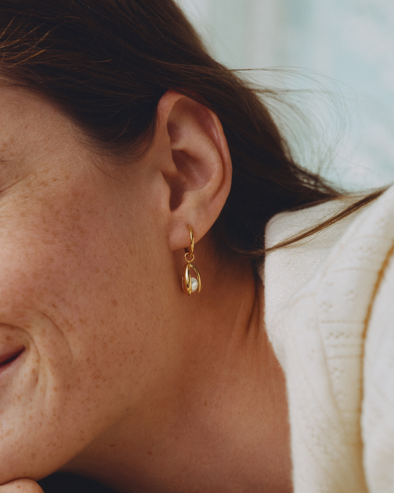Edblad Moonrave Hoops L Gold Earrings worn by a model