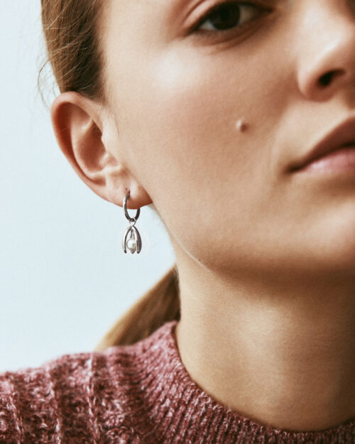 Edblad Moonrave Hoops L Steel Earrings worn by a model